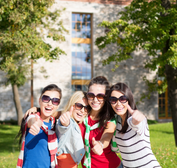 teenage girls or young women showing thumbs up Stock photo © dolgachov