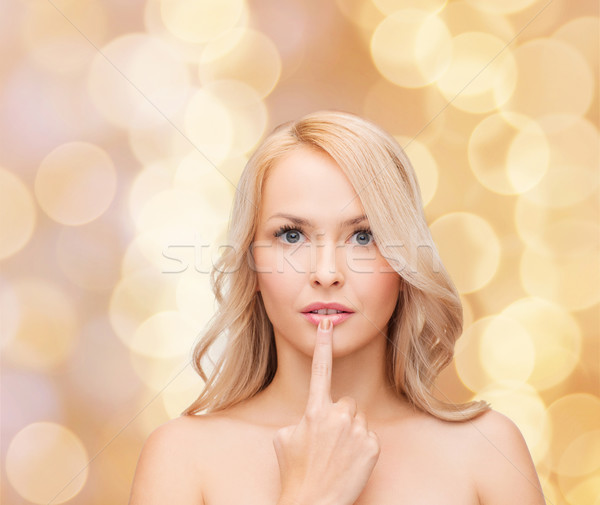 woman touching her lips Stock photo © dolgachov