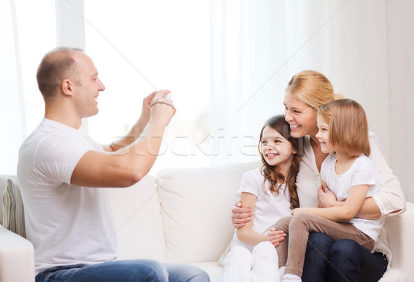 Stock photo: father taking picture of mother and daughters