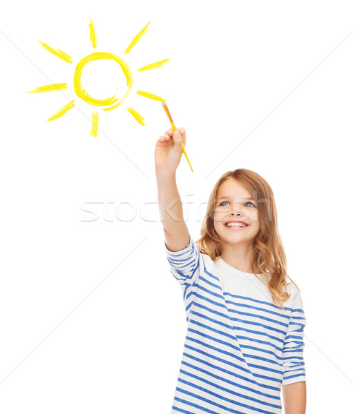 cute little girl drawing sun with brush Stock photo © dolgachov