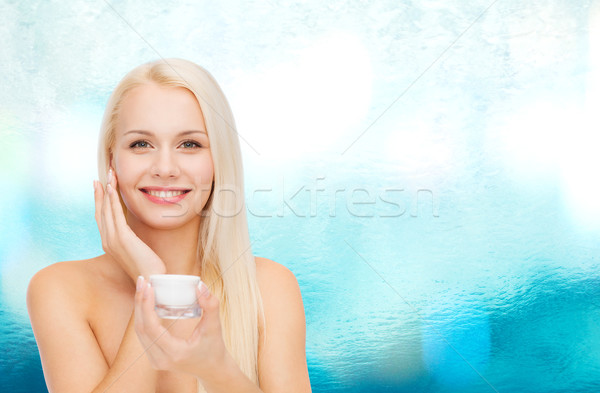 woman applying cream on her skin Stock photo © dolgachov