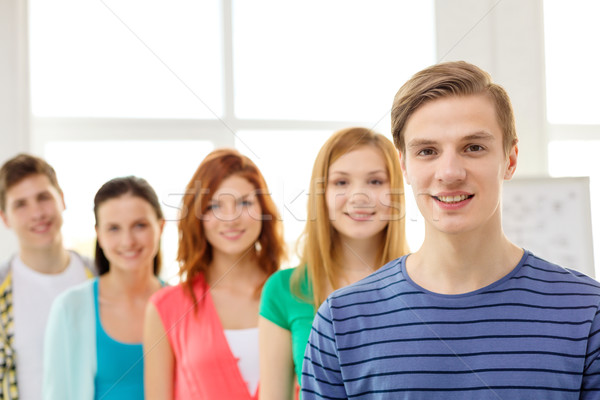 smiling students with teenage boy in front Stock photo © dolgachov