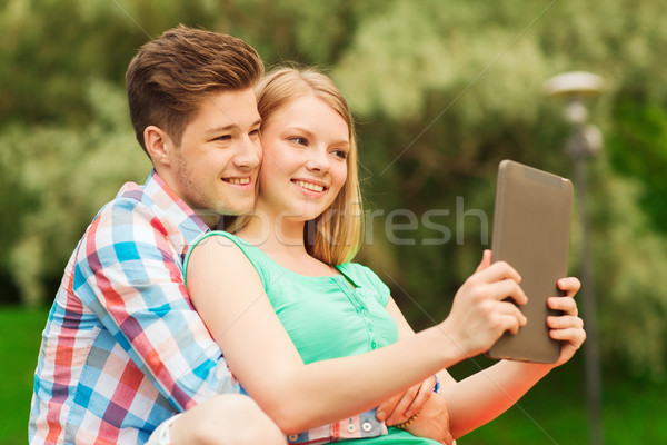 smiling couple with tablet pc making selfie Stock photo © dolgachov