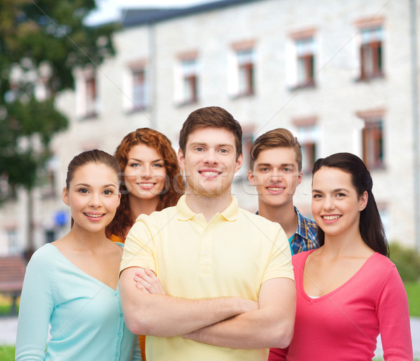 group of smiling teenagers over campus background Stock photo © dolgachov