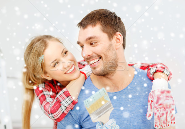 smiling couple with paintbrush at home Stock photo © dolgachov