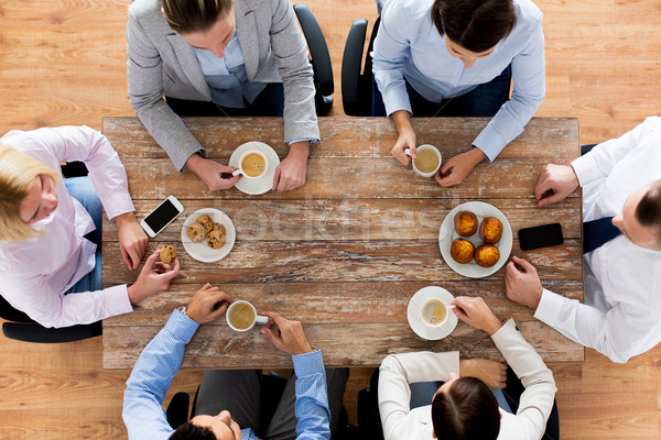 close up of business team drinking coffee on lunch Stock photo © dolgachov