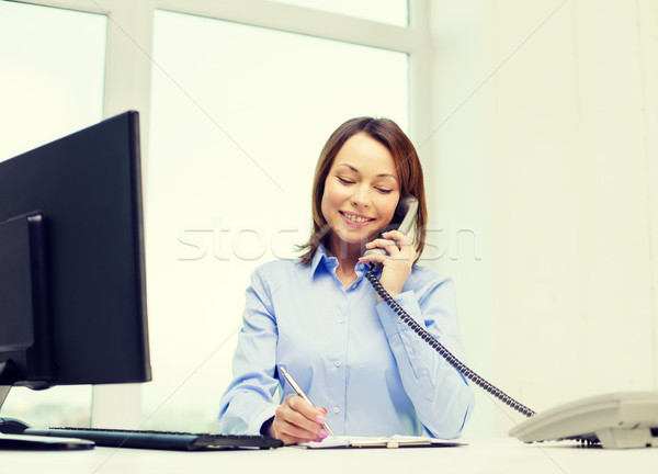 Stock photo: businesswoman with laptop, files and telephone