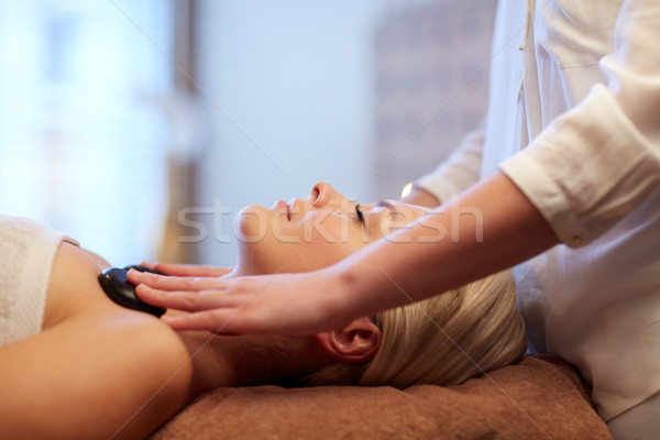 close up of woman having hot stone massage in spa Stock photo © dolgachov