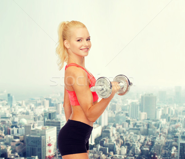 young sporty woman with heavy steel dumbbell Stock photo © dolgachov