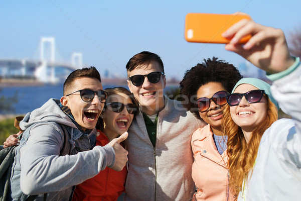 happy friends taking selfie with smartphone Stock photo © dolgachov