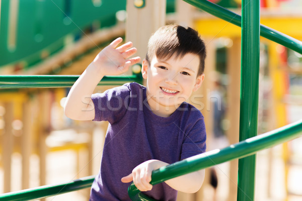 Stock photo: happy little boy climbing on children playground