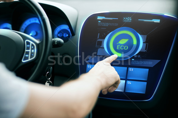 male hand setting car eco system mode on screen Stock photo © dolgachov