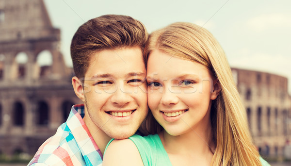 smiling couple over coliseum background Stock photo © dolgachov