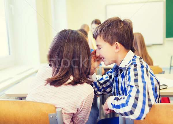 Mosolyog iskolás lány suttog osztálytárs fül oktatás Stock fotó © dolgachov
