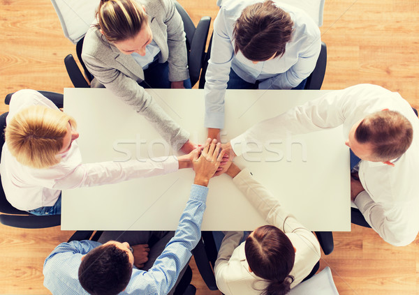 close up of business team with hands on top Stock photo © dolgachov