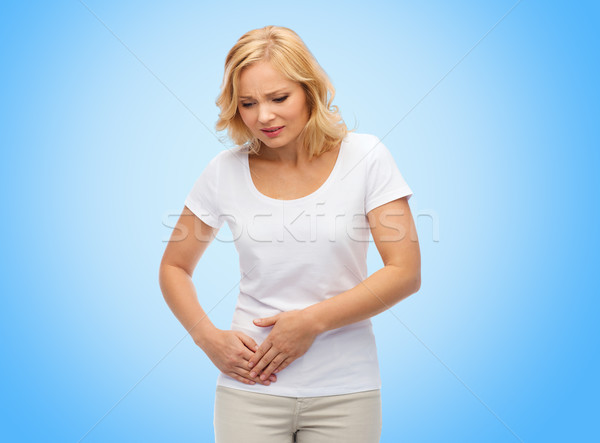 unhappy woman suffering from stomach ache Stock photo © dolgachov