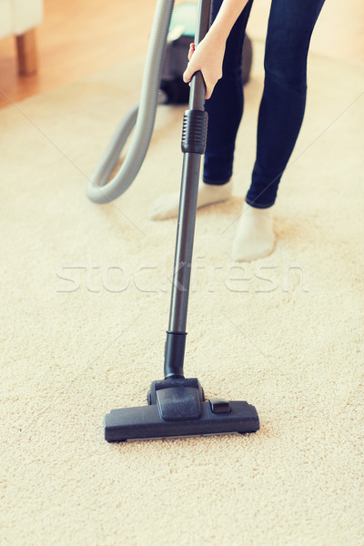 close up of woman legs with vacuum cleaner at home Stock photo © dolgachov