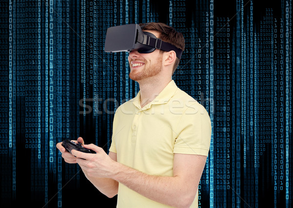 happy man in virtual reality headset with gamepad Stock photo © dolgachov