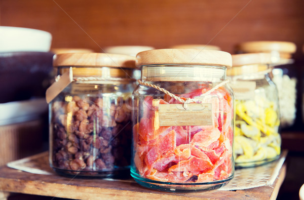 close up of jars with dried fruits at grocery Stock photo © dolgachov