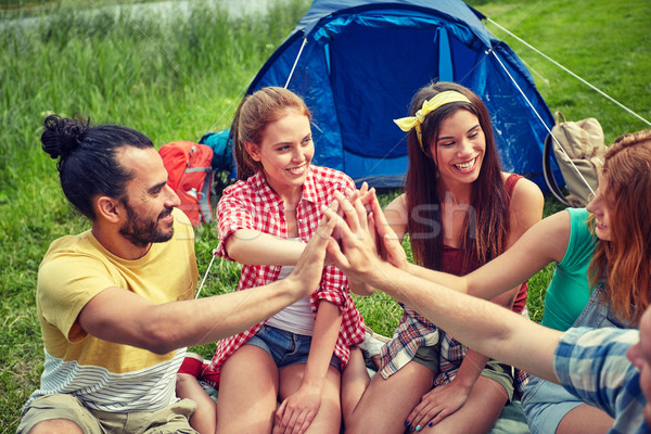 happy friends making high five at camping Stock photo © dolgachov