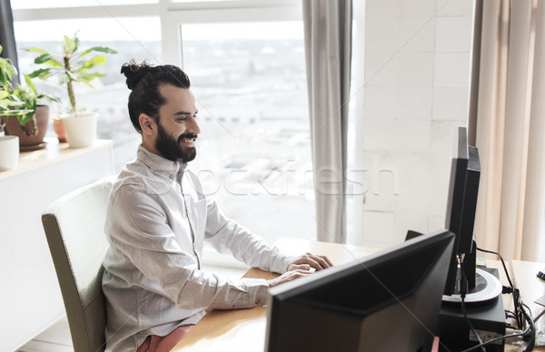 happy creative male office worker with computer Stock photo © dolgachov