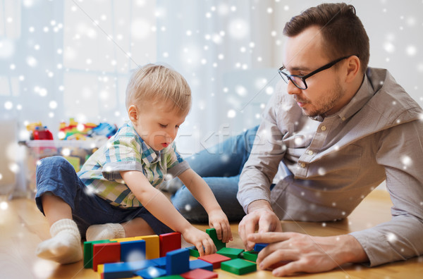 father and son playing with toy blocks at home Stock photo © dolgachov