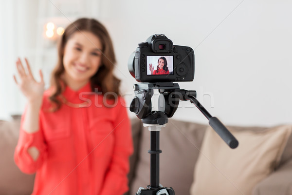 happy woman with camera recording video at home Stock photo © dolgachov