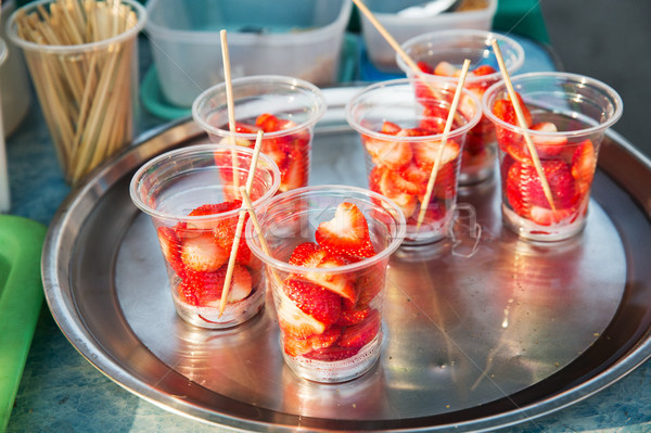 strawberry in plastic cups at street market Stock photo © dolgachov