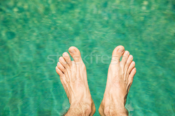 male feet over sea water Stock photo © dolgachov