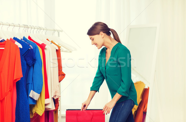 happy woman with shopping bags and clothes at home Stock photo © dolgachov