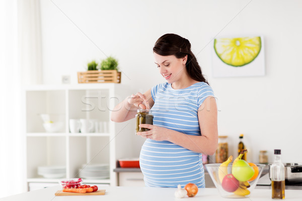 Kobieta w ciąży jedzenie ogórki konserwowe domu kuchnia ciąży Zdjęcia stock © dolgachov