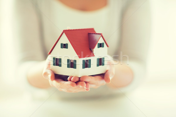 close up of hands holding house or home model Stock photo © dolgachov