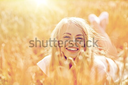 happy young woman in sun hat on cereal field Stock photo © dolgachov