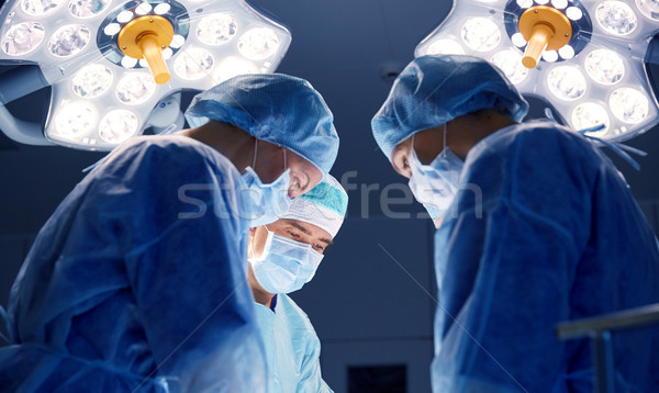 Stock photo: group of surgeons in operating room at hospital