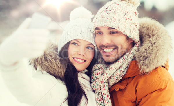happy couple taking selfie by smartphone in winter Stock photo © dolgachov