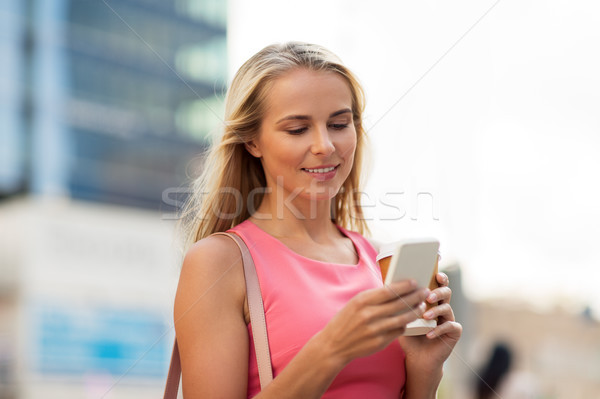 woman with coffee and smartphone in city Stock photo © dolgachov