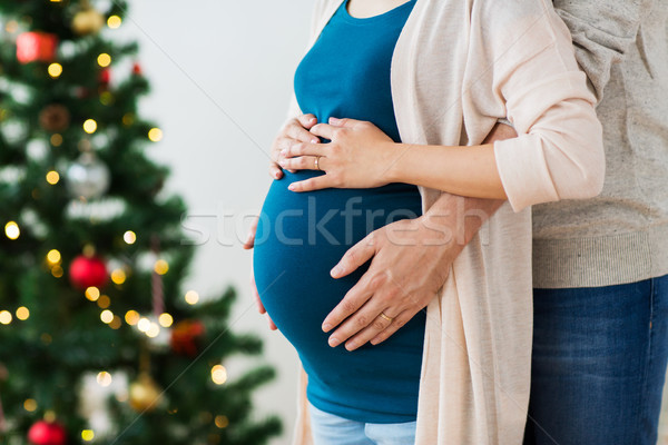 Stock photo: man and pregnant woman home at christmas
