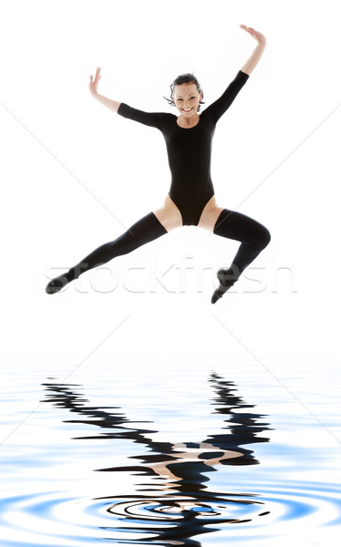 girl in black leotard jumping over water Stock photo © dolgachov