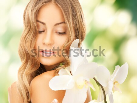 Stock photo: beautiful woman with orchid flower