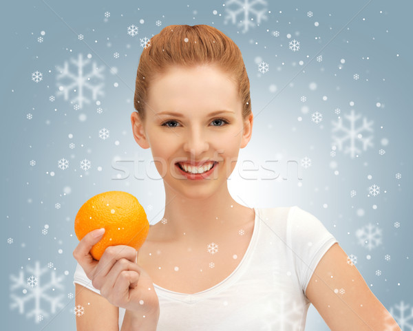teenage girl with orange Stock photo © dolgachov
