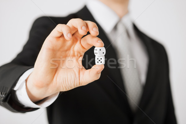 mans hand holding white casino dice Stock photo © dolgachov