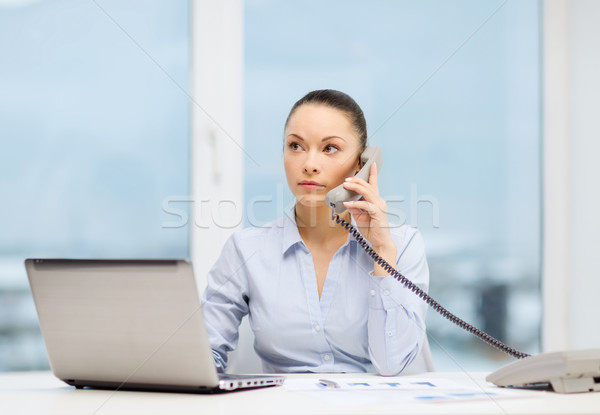 businesswoman with phone, laptop and files Stock photo © dolgachov