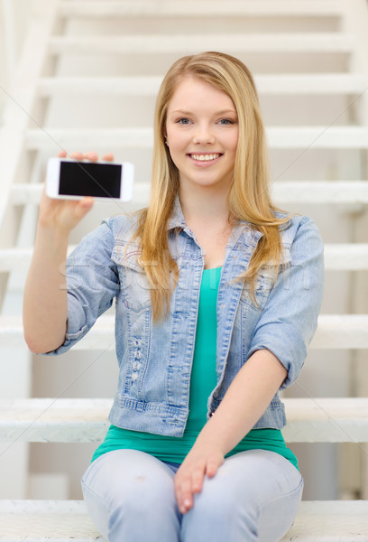 smiling student with smartphone blank screen Stock photo © dolgachov