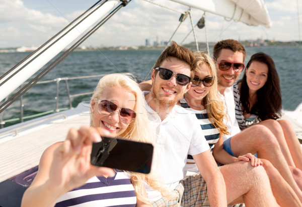 smiling friends sitting on yacht deck Stock photo © dolgachov