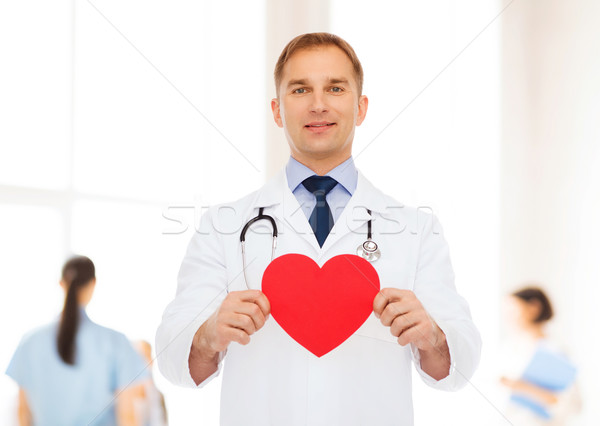 Sorridere medico di sesso maschile rosso cuore stetoscopio medicina Foto d'archivio © dolgachov