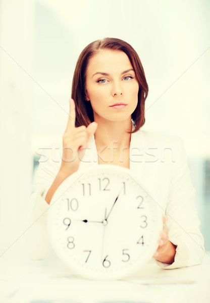 attractive businesswoman with white clock Stock photo © dolgachov