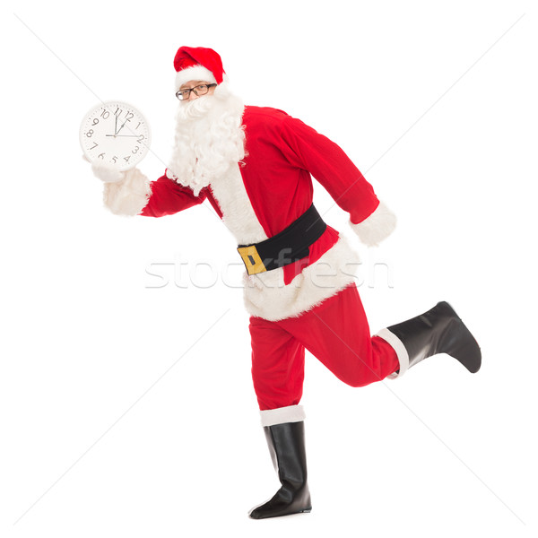man in costume of santa claus with clock Stock photo © dolgachov