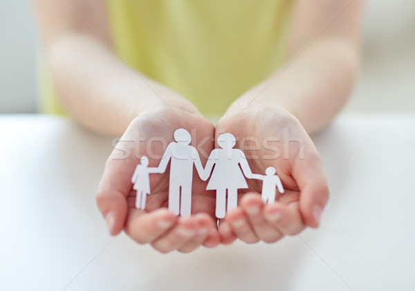 close up of child hands with paper family cutout Stock photo © dolgachov