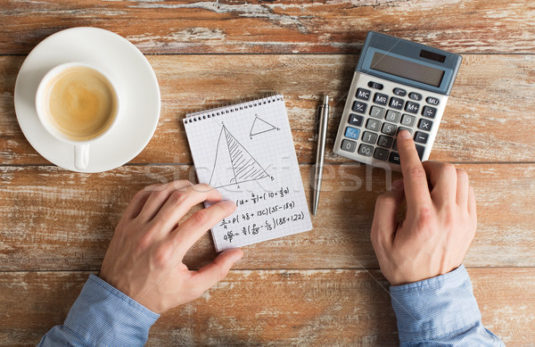 close up of hands with calculator solving task Stock photo © dolgachov