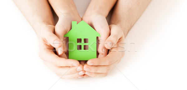 man and woman hands with green paper house Stock photo © dolgachov